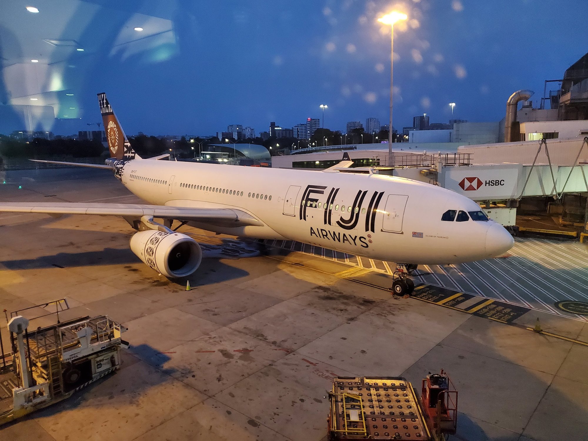 Fiji Airways plane at gate at dusk